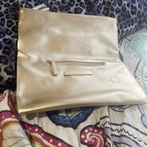 Monat make up bag. Gold and very compact full. Can put anything in it. Love it.